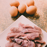 Buy canvas prints of Raw meat and eggs for cooking by Joaquin Corbalan