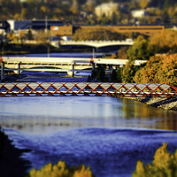 Buy canvas prints of The Red Bridge over the bow River  by Osarieme Eweka
