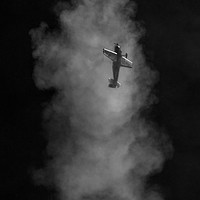 Buy canvas prints of  Aerobatic plane emerging from its smoke trail by louise stanley