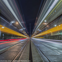 Buy canvas prints of Passing light trails from 2 trams in Manchester by Katie McGuinness