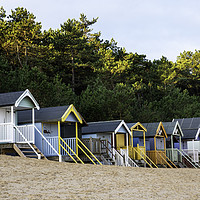 Buy canvas prints of colourful wells beach huts by Robbie Spencer