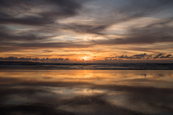 Moody sunset reflections at Westward Ho! Picture Board by Tony Twyman