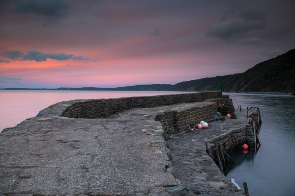 sunset at the harbour wall of Clovelly in Devon Picture Board by Tony Twyman