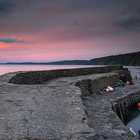 Buy canvas prints of sunset at the harbour wall of Clovelly in Devon by Tony Twyman