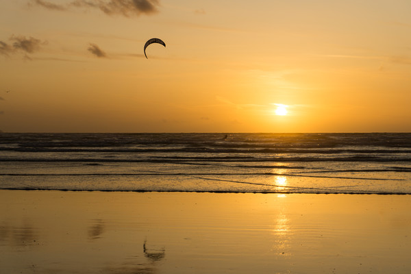 Sunset kite surfer at Westward Ho! in Devon Picture Board by Tony Twyman