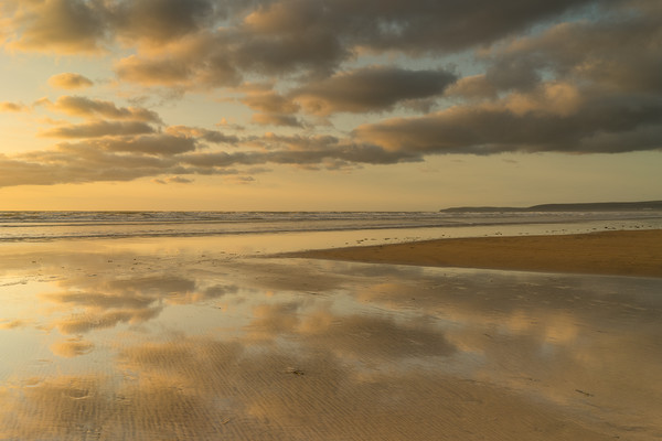 Reflective sunset clouds at Westward Ho! in Devon Picture Board by Tony Twyman