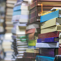 Buy canvas prints of Close-up of stacks of old books, selective focus. by RUBEN RAMOS