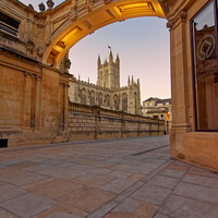 Buy canvas prints of Bath Abbey framed by the York Street archway at dusk by Duncan Savidge