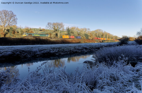 Freightliner passes the white frozen landscape of the river Avon near Freshford Picture Board by Duncan Savidge