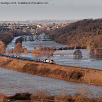 Buy canvas prints of A freight train crosses flooded fields through Corston near Bath by Duncan Savidge
