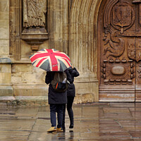 Buy canvas prints of Union jack umbrella outside Bath Abbey by Duncan Savidge