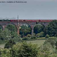 Buy canvas prints of 60103 Flying Scotsman in the landscape crossing Huckford Viaduct by Duncan Savidge