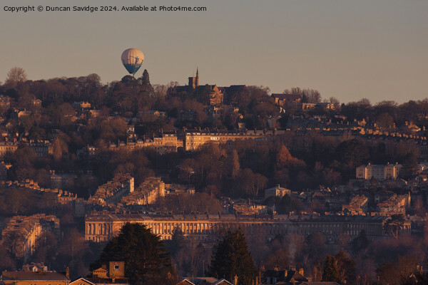Hot air balloon floats over the golden Royal Crescent in winter  Picture Board by Duncan Savidge