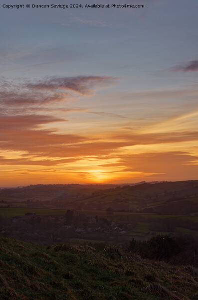 Portrait of the winter sunset over Englishcombe  Picture Board by Duncan Savidge