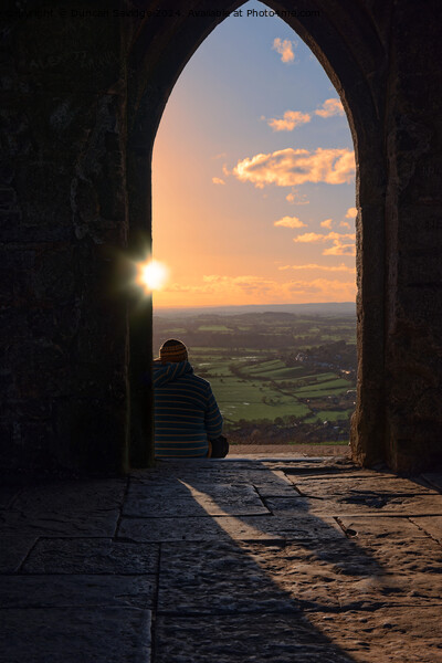 Sunset through the arch at Glastonbury Tor Picture Board by Duncan Savidge