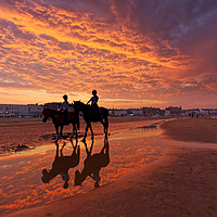 Buy canvas prints of Fiery  sunset on weymouth beach horses by Duncan Savidge