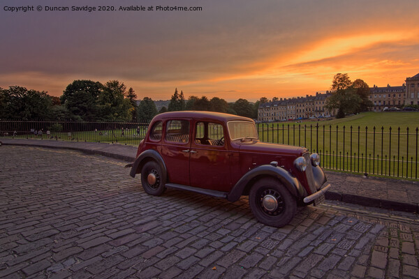 Royal Crescent Bath at sunset with an old fashioned car Picture Board by Duncan Savidge