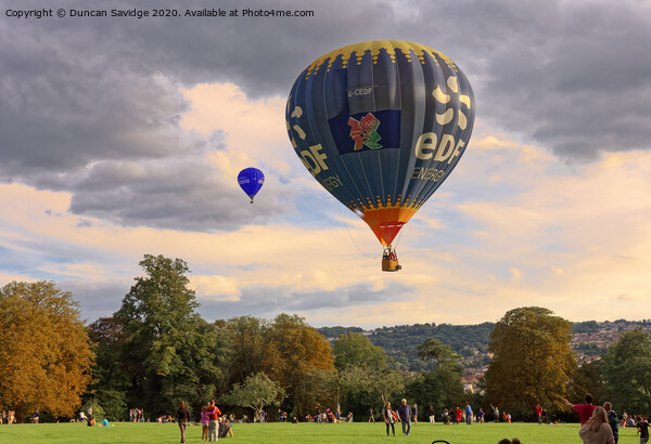 Hot air balloon lifting off from Royal Victoria Park Bath Picture Board by Duncan Savidge
