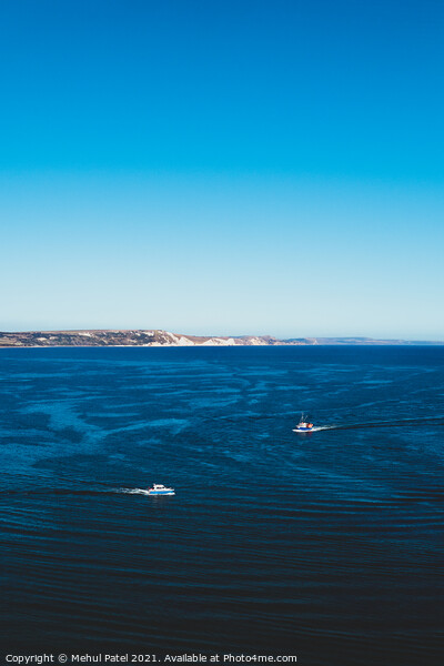 Two boats travelling across blue waters of Weymout Picture Board by Mehul Patel