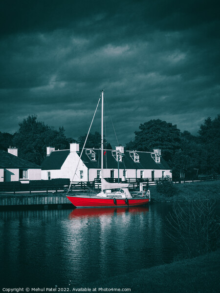 Red sailboat moored in water near traditional style homes Picture Board by Mehul Patel