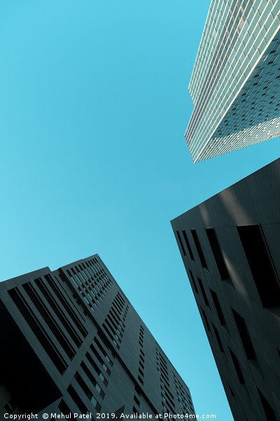 Tall skyscrapers against clear turquoise sky  Picture Board by Mehul Patel