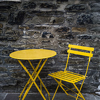 Buy canvas prints of Yellow chair and table by stone wall  by Mehul Patel
