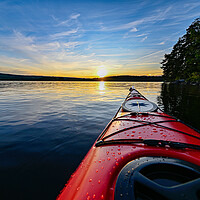 Buy canvas prints of red plastic kayak on calm water in the sunset by Jonas Rönnbro