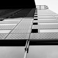 Buy canvas prints of Modern and tall office buliding with sky over top by M. J. Photography