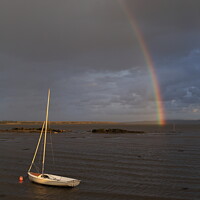 Buy canvas prints of The rainbow over a boat by Pawel Burdzynski