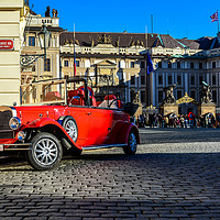 Buy canvas prints of Vintage red car and the Prague Castle by Jelena Maksimova