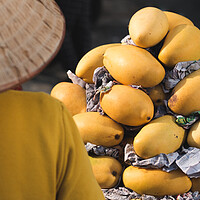 Buy canvas prints of Mangoes at Market in Vietnam by David Bokuchava