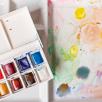 Buy canvas prints of box of watercolors on a paint-stained palette by David Galindo