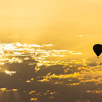 Buy canvas prints of hot air balloon in the sky with orange sunrise clouds by David Galindo