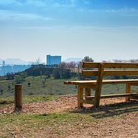 Buy canvas prints of empty wooden bench in spring park over the city by David Galindo
