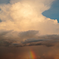 Buy canvas prints of Cumulus storm cloud and rainbow by Simon Johnson