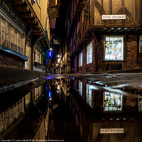 Buy canvas prints of The Shambles, York - Nighttime Reflections on the Historic Roman Street by Lewis Gabell