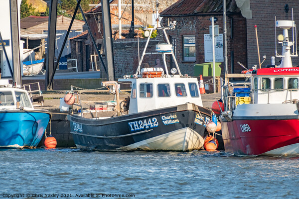 Commercial fishing boats in the port of Wells-Next-The-Sea, North Norfolk Picture Board by Chris Yaxley