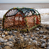 Buy canvas prints of Crab fishing pot on Cromer beach, Norfolk coast by Chris Yaxley