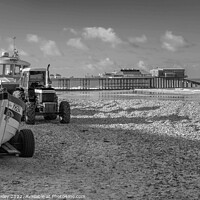 Buy canvas prints of Black and white vintage photo of fishing boats and equipment on Cromer beach on the North Norfolk Coast. In the distance is the Victorian era pier by Chris Yaxley