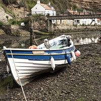 Buy canvas prints of Fishing boat in the seaside village of Staithes by Chris Yaxley