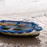 Buy canvas prints of Row boat beached at low tide by Chris Yaxley