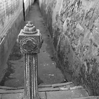 Buy canvas prints of Metal post restricting alleyway access by Chris Yaxley