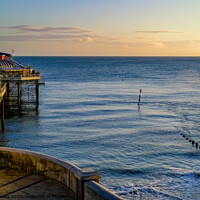 Buy canvas prints of Cromer pier and promenade at sunrise by Chris Yaxley