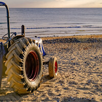 Buy canvas prints of Rear view of tractor on Cromer beach at sunrise by Chris Yaxley
