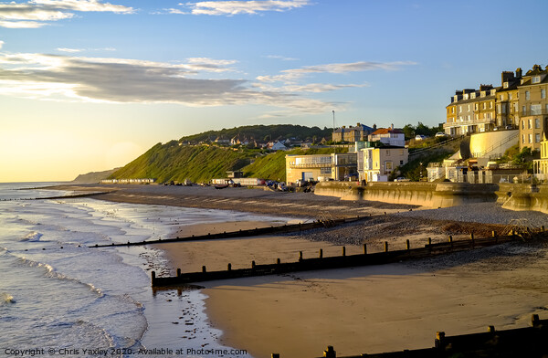 A view across Cromer beach at sunrise from the pier Picture Board by Chris Yaxley