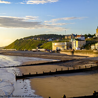 Buy canvas prints of A view across Cromer beach at sunrise from the pier by Chris Yaxley