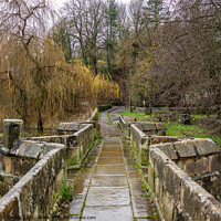 Buy canvas prints of Stone bridge over a raging River Wye, Bakewell by Chris Yaxley