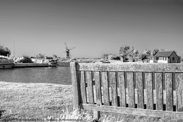 Wooden bench on the bank of the River Thurne Picture Board by Chris Yaxley