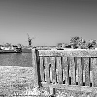 Buy canvas prints of Wooden bench on the bank of the River Thurne by Chris Yaxley