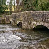 Buy canvas prints of Sheepwash Bridge over a raging River Wye in Ashford in the Water, Derbyshire by Chris Yaxley